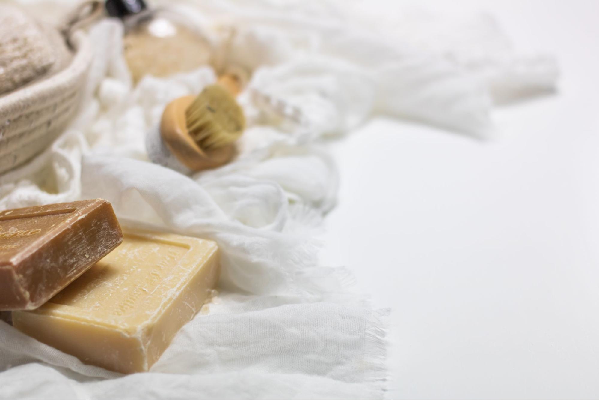 Soap bars and a towel on white background