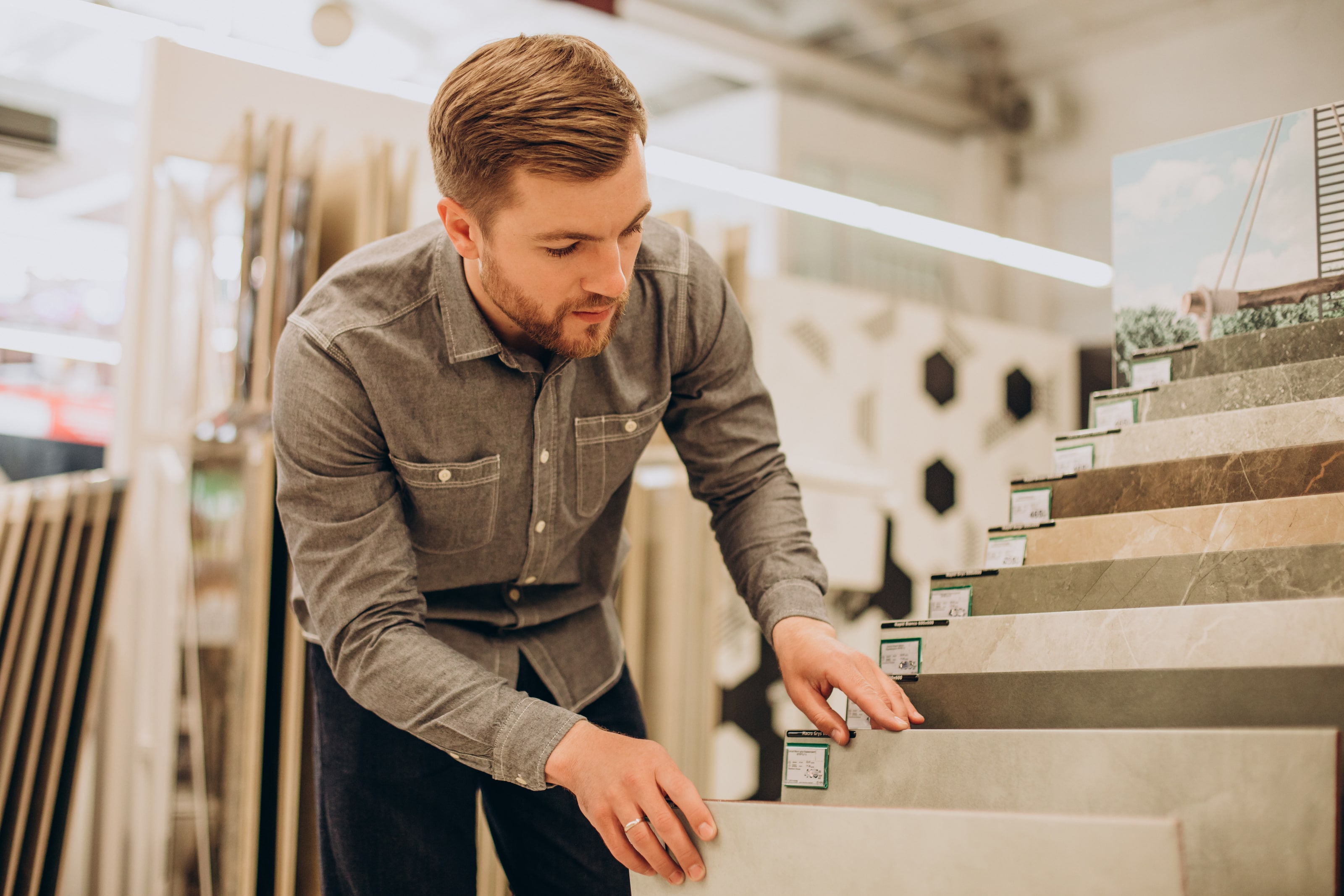 young man choosing tiles